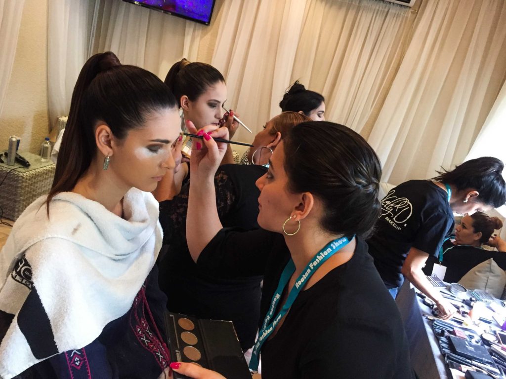 The models backstage getting their make-up done for The Roatan Fashion Show 2016